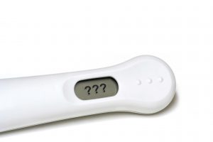 Pregnancy Test Stick with Question Marks on the Screen